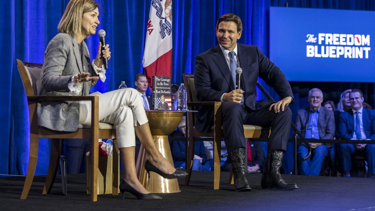 Reynolds and Florida Gov. Ron DeSantis are seen during an event in Des Moines on March 10, 2023. 